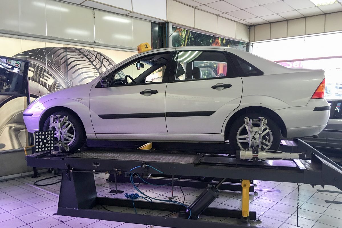Vehicle raised on a shop lift for inspection at an automotive service centre